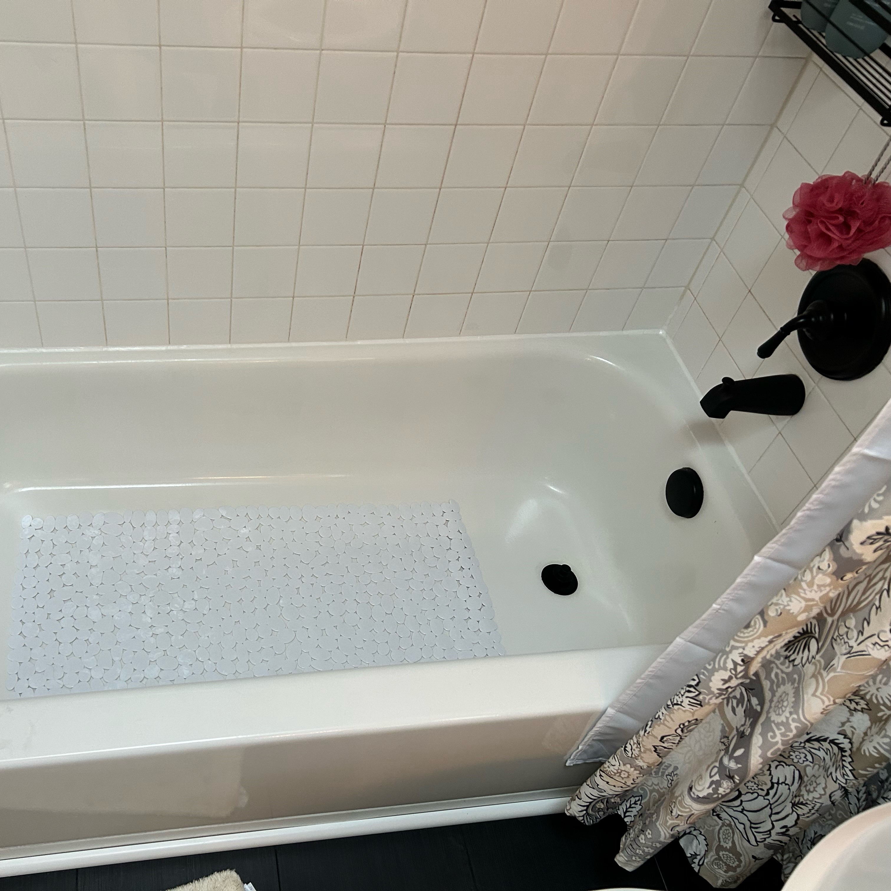 white bathtub and white tile with matte black fixtures.